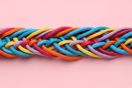 Colorful ropes tied together on pink background, top view. Unity conceptの写真素材