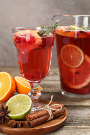 Aromatic punch drink, fresh fruits and spices on wooden table, closeupの写真素材