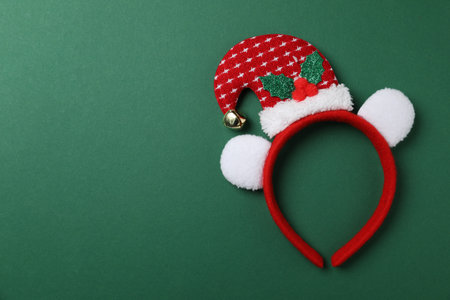Stylish party headband on green background, top view with space for text. Christmas accessoryの写真素材