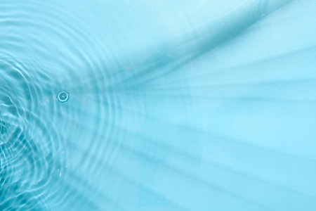 Rippled surface of clear water on light blue background, top viewの写真素材
