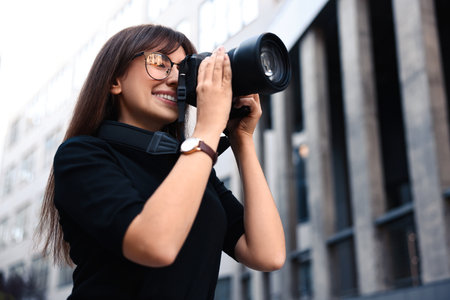 Professional photographer taking picture with camera outdoorsの写真素材