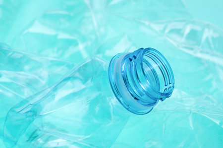 Crumpled plastic bottles on turquoise background, closeupの写真素材