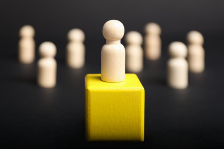 Winner concept. One piece on yellow podium and other on table against black background, selective focusの写真素材