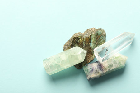 Beautiful natural gemstones on light blue background, top view. Space for textの写真素材