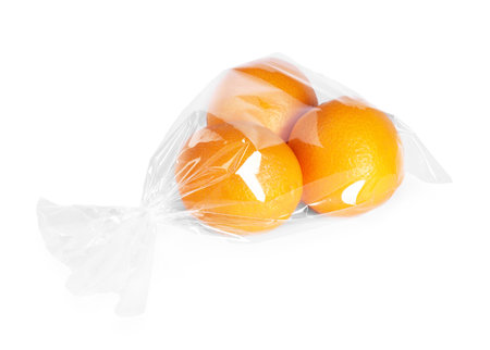 Plastic bag with fresh oranges isolated on whiteの写真素材
