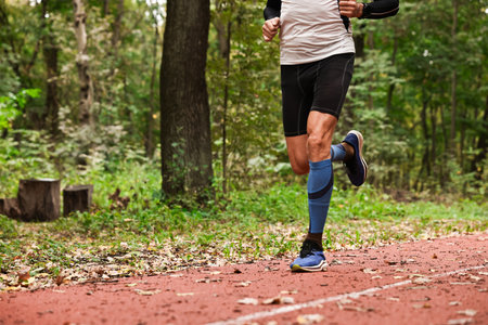 Athletic man running in park, closeup. Space for text