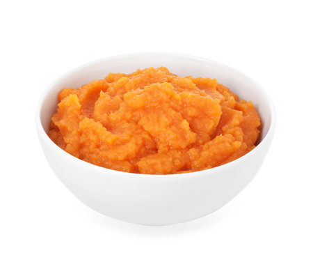 Tasty mashed sweet potato in bowl isolated on whiteの写真素材