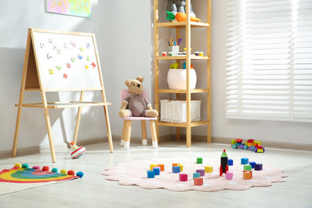 Beautiful child's room interior with toys and stylish furnitureの写真素材