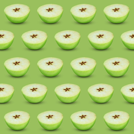 Halves of fresh apple on light green background, seamless pattern