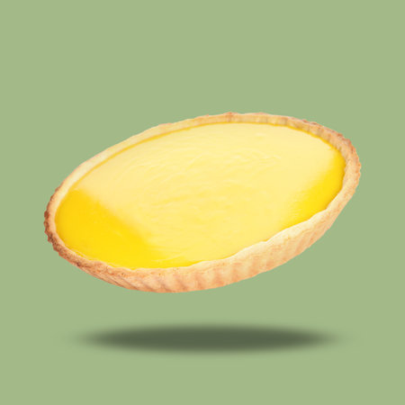 Delicious lemon pie in air on light green backgroundの写真素材