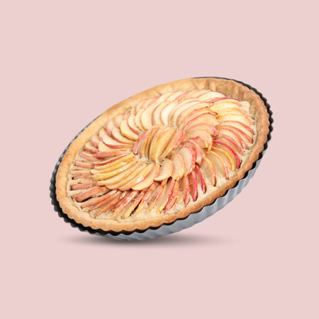 Delicious apple tart in air on pink backgroundの写真素材