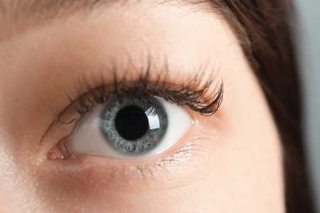 Macro view of young woman with beautiful blue eyesの写真素材