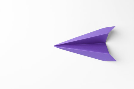 One handmade purple paper plane on white background, top view. Space for textの写真素材