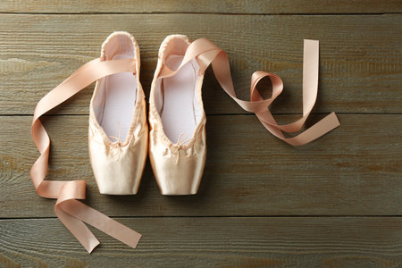 Pair of beautiful pointe shoes on wooden background, top viewの写真素材