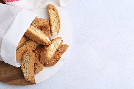 Traditional Italian almond biscuits (Cantucci) on light table, top view. Space for text
