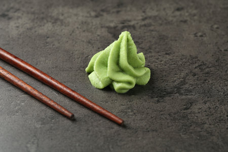 Wasabi paste and chopsticks on grey textured table, closeupの写真素材