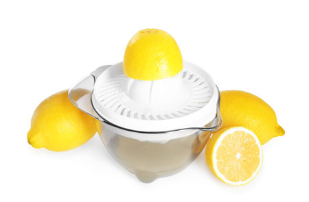 Juicer and fresh lemons isolated on whiteの写真素材