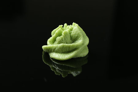 Hot wasabi paste on black mirror surface, closeupの写真素材
