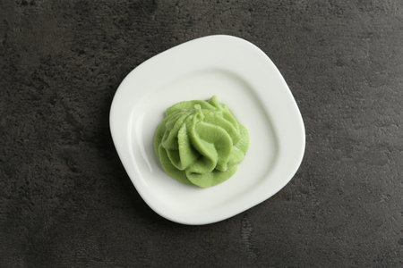 Plate with wasabi paste on gray textured table, top viewの写真素材