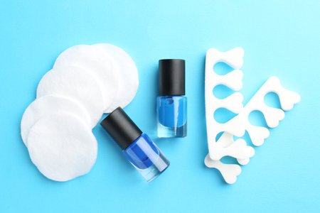 Set of pedicure tools on light blue background, flat layの写真素材