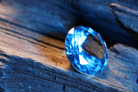 Beautiful shiny light blue gemstone on stone, closeupの写真素材