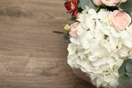 Bouquet of beautiful flowers on wooden table, top view. Space for text