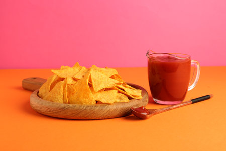 Tasty ketchup and nachos on pink backgroundの写真素材