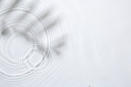 Rippled surface of clear water on white background, top view