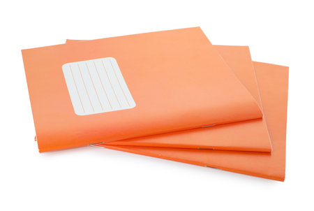 Orange copybooks isolated on white. School stationeryの写真素材