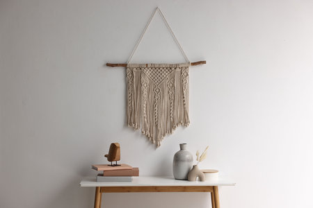 Stylish console table with decor near white wall indoors
