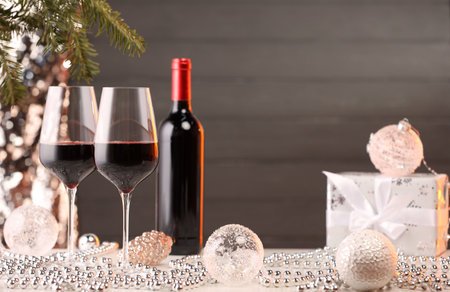 Red wine and beautiful Christmas decor on white tableの写真素材