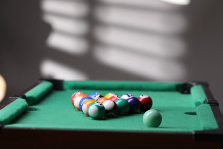 Billiard balls in triangle on green table indoors.の写真素材