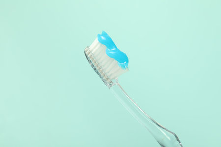 Toothbrush with toothpaste on light blue background, closeupの写真素材