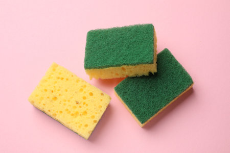 Soft sponges on pink background, top view. Cleaning toolの写真素材