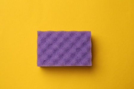 Soft sponge on yellow background, top view. Cleaning toolの写真素材