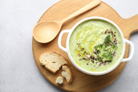 Delicious broccoli cream soup served on light table, top viewの写真素材