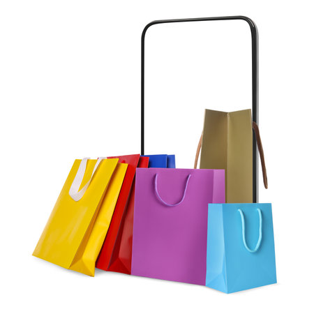 Mobile phone with shopping bags isolated on white. Concept of online shopping, purchase via internetの写真素材