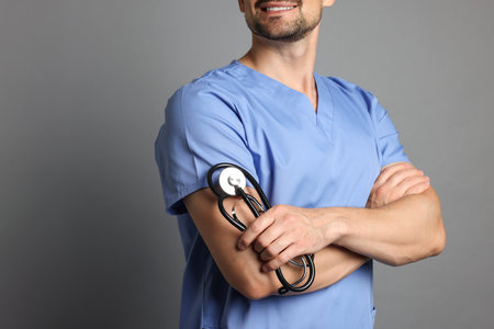 Nurse with stethoscope on grey background, closeupの写真素材