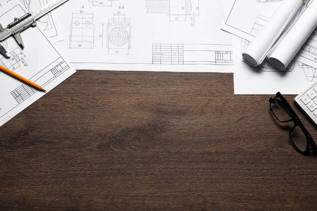 Different architectural drawings and tools wooden table, flat lay. Space for textの写真素材