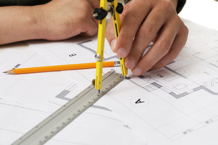 Architect working with project, closeup. Different technical drawings on table