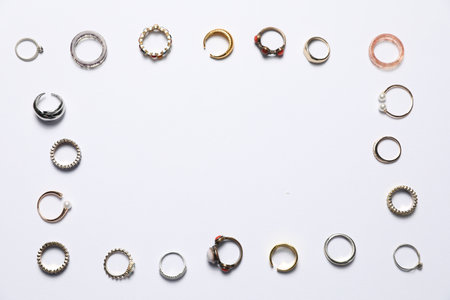 Frame made of many different rings on white background, flat lay. Space for textの写真素材