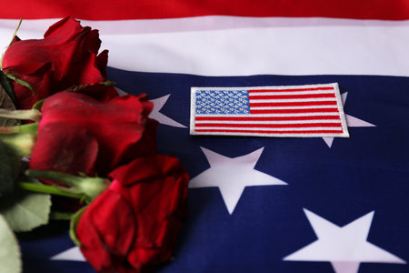 Veterans day. American army patch and rose flowers on USA flag, closeupの写真素材