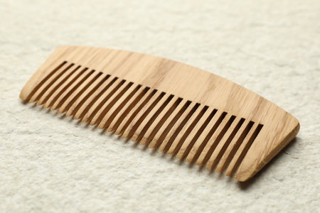 One wooden hair comb on beige background, closeupの写真素材