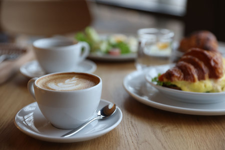Delicious breakfast served on wooden table in cafe, closeupの写真素材