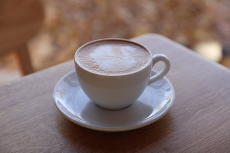 Cup of aromatic coffee on wooden table in cafe, closeupの写真素材