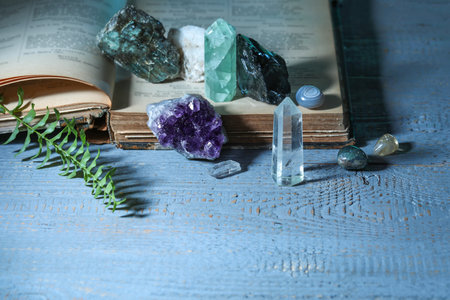 Beautiful natural gemstones and book on gray table, closeupの写真素材