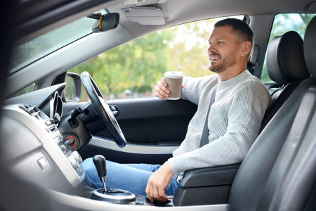 Man driving modern car, view through windowの写真素材