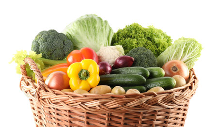Different fresh vegetables in wicker basket isolated on whiteの写真素材