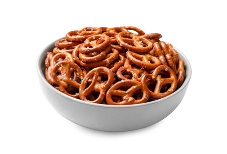 Tasty pretzel crackers in bowl isolated on whiteの写真素材