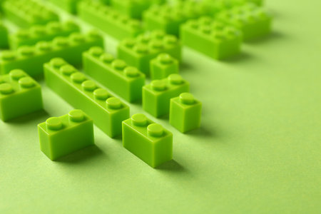 Constructor toy. Many building blocks on light green background, closeupの写真素材
